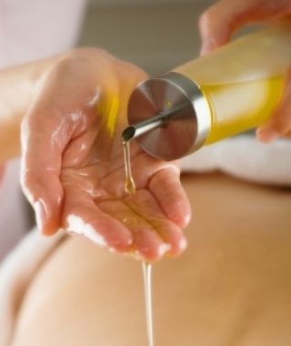 Massage oil pouring into a hand