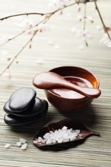 Massage bowl, massage stones and a wooden bowl